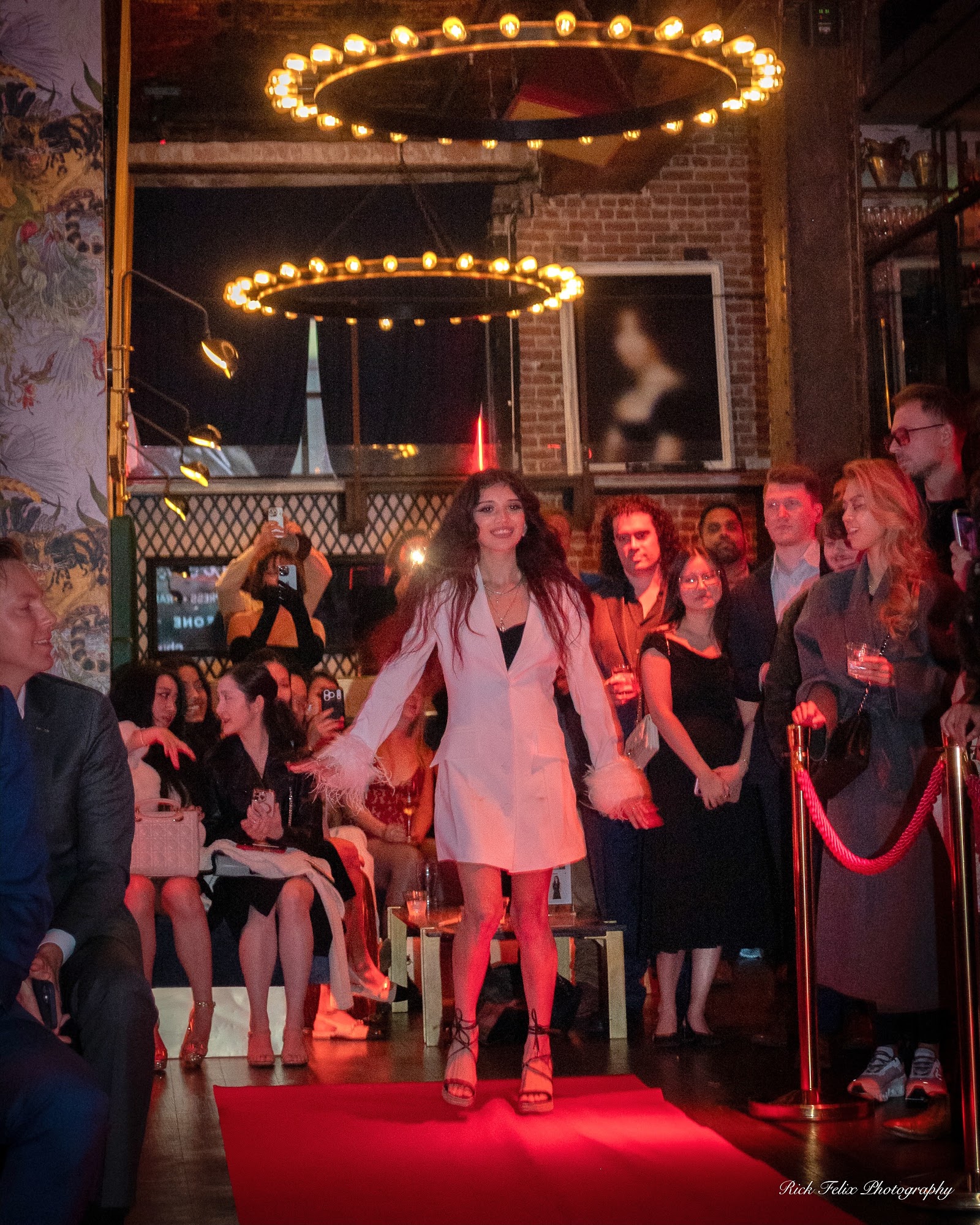 Model finishing a walk in front of a full crowd