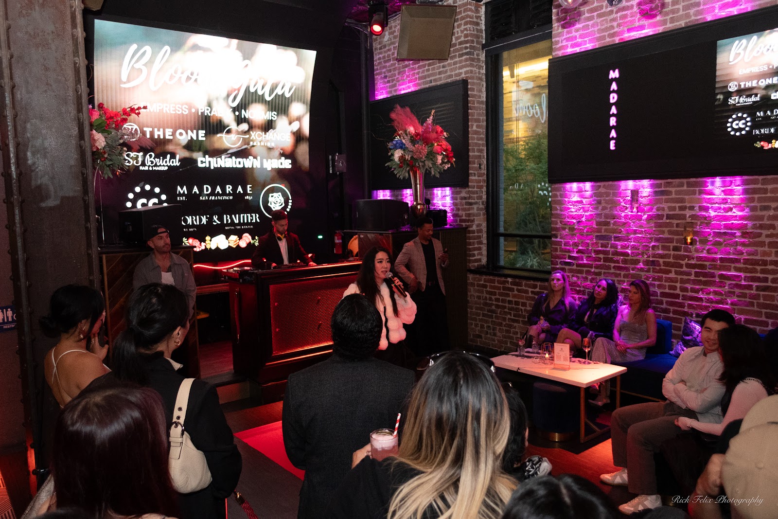 Guests gathered around the DJ booth and partner wall