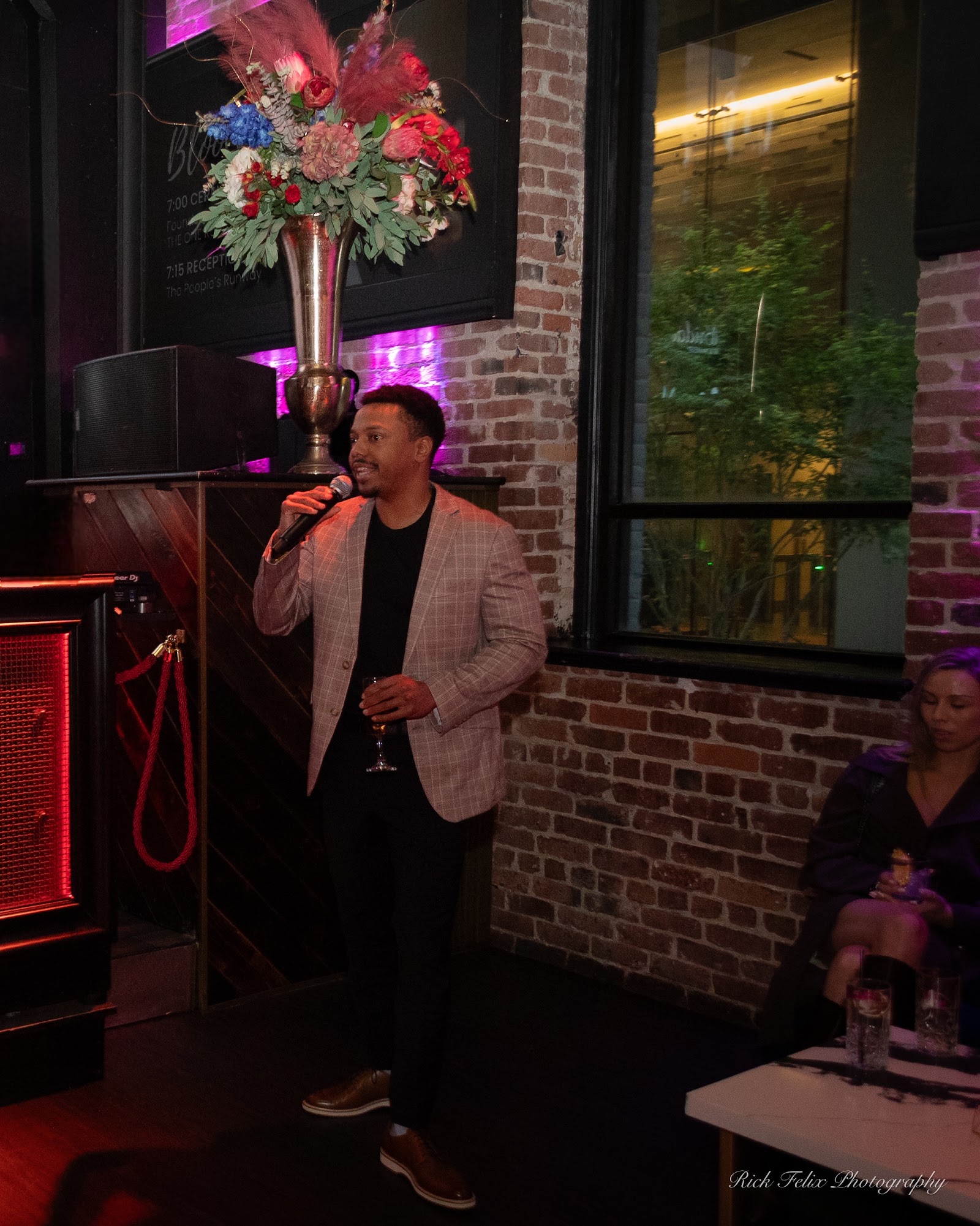 Host addressing guests with a microphone