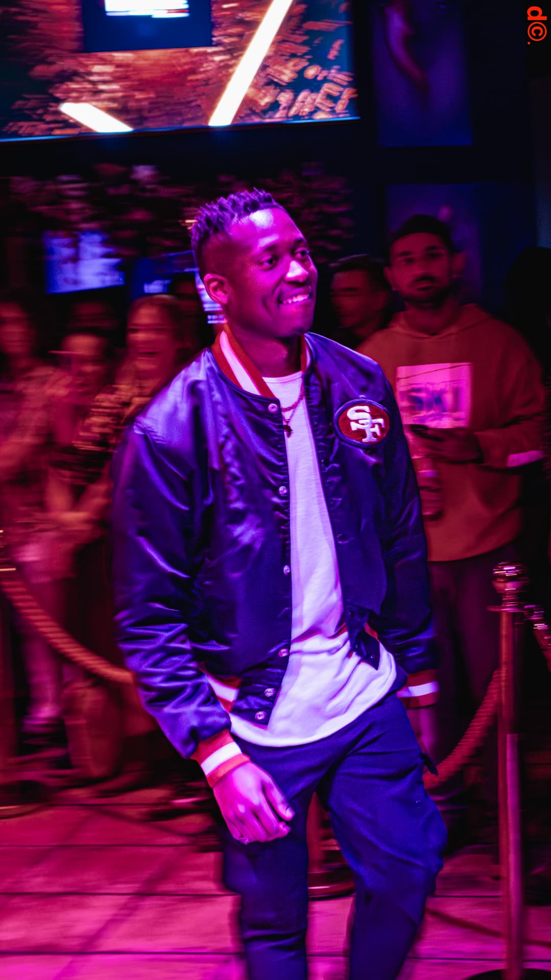 Guest walking the runway in a satin SF bomber jacket