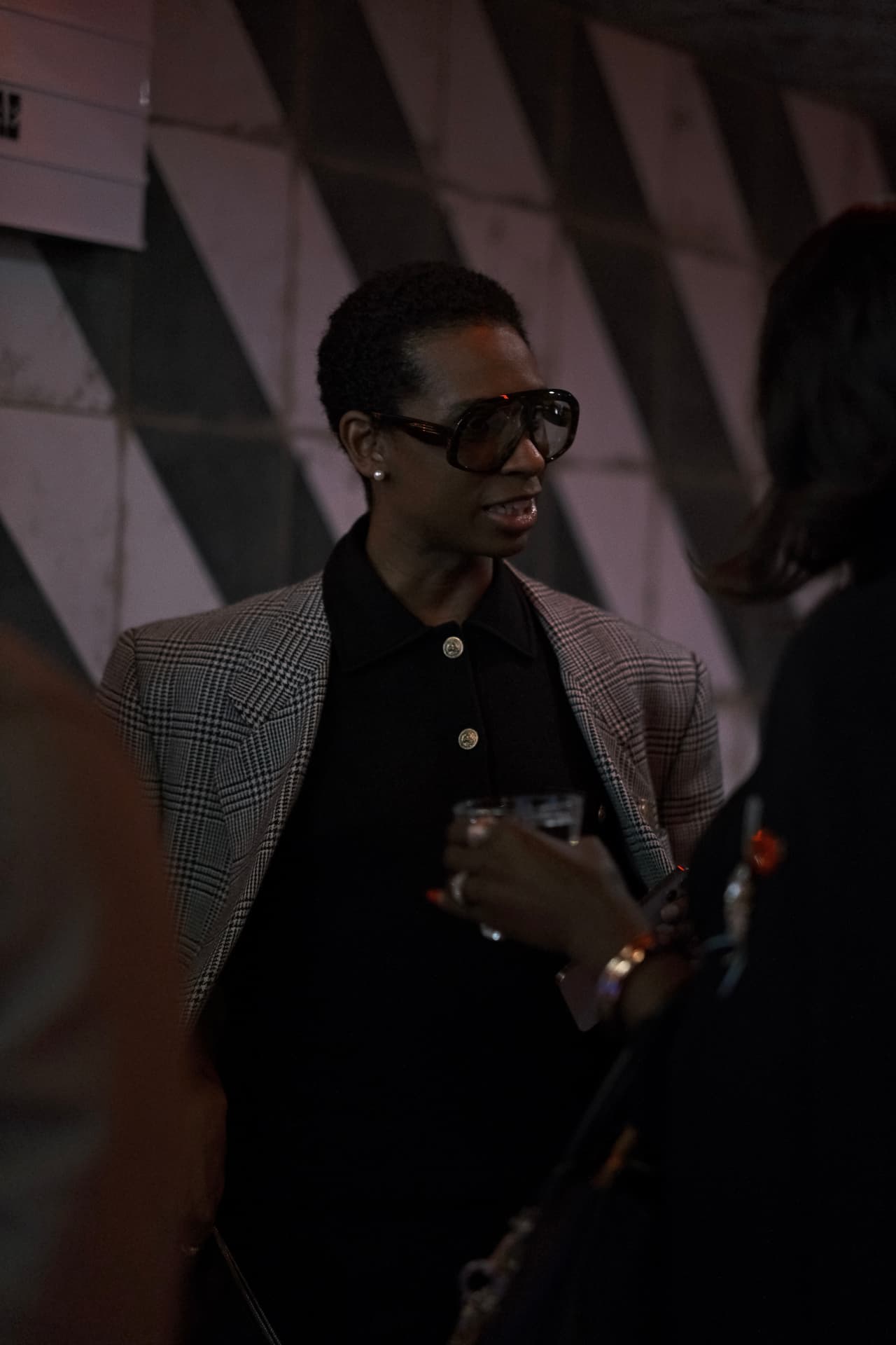 Guest in a plaid blazer at an Xchange Fashion event