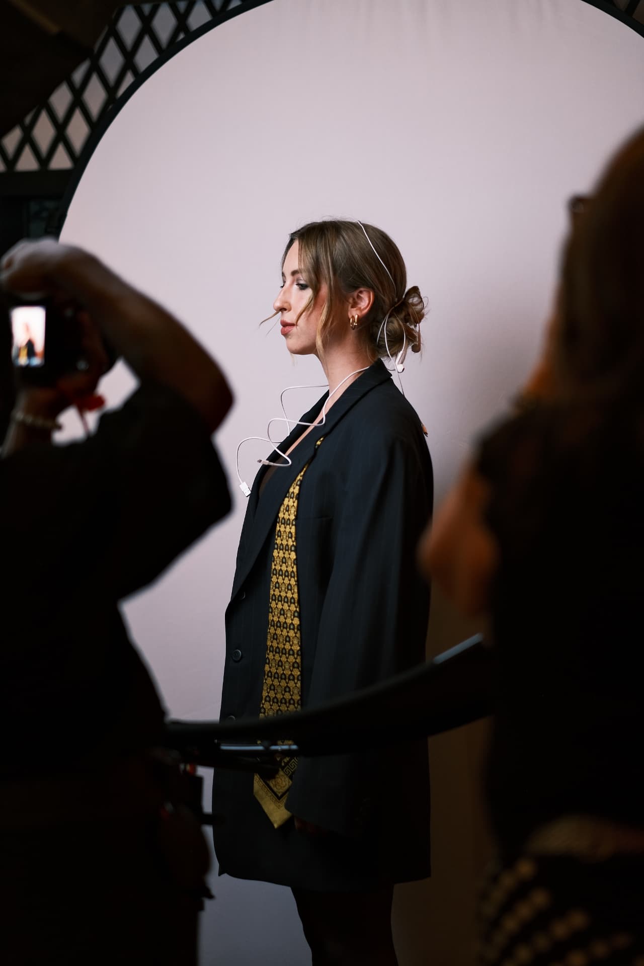 A model posing in profile during a studio photoshoot