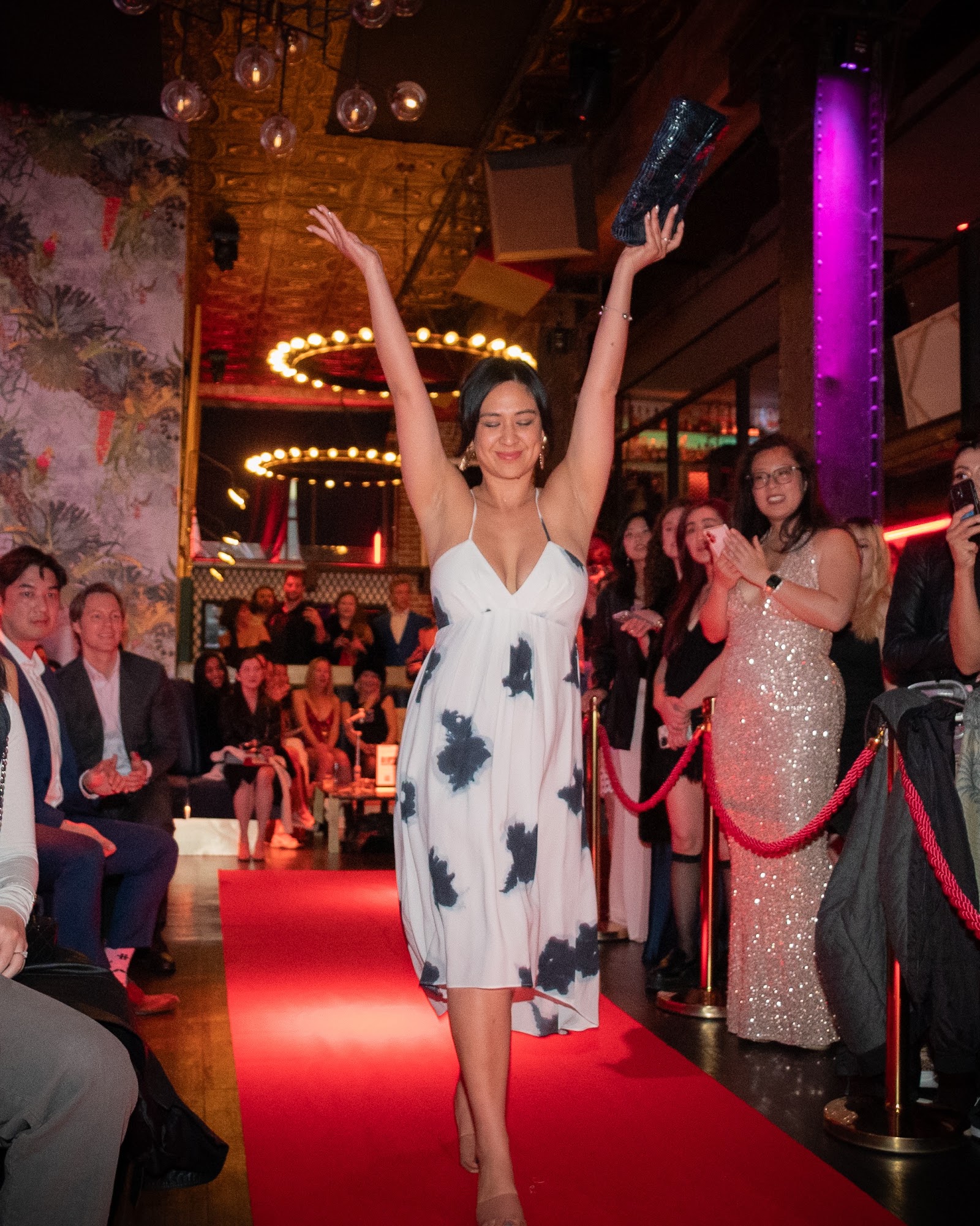 Guest celebrating at the end of the Xchange Fashion runway in San Francisco